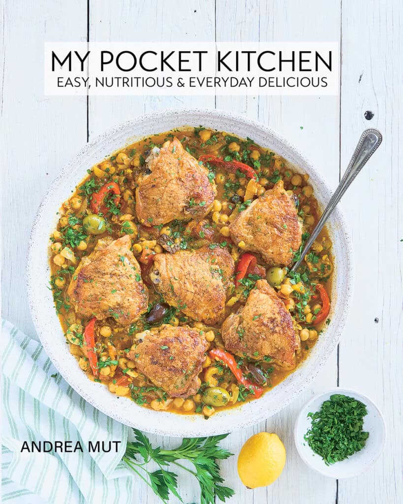 Cookbook cover with a chicken and vegetable dish on a large serving platter.