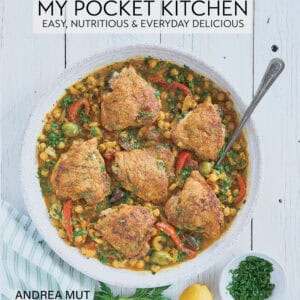 Cookbook cover with a chicken and vegetable dish on a large serving platter.
