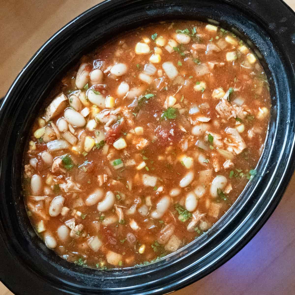 Buffalo chicken chili ready to serve out of the slow cooker.