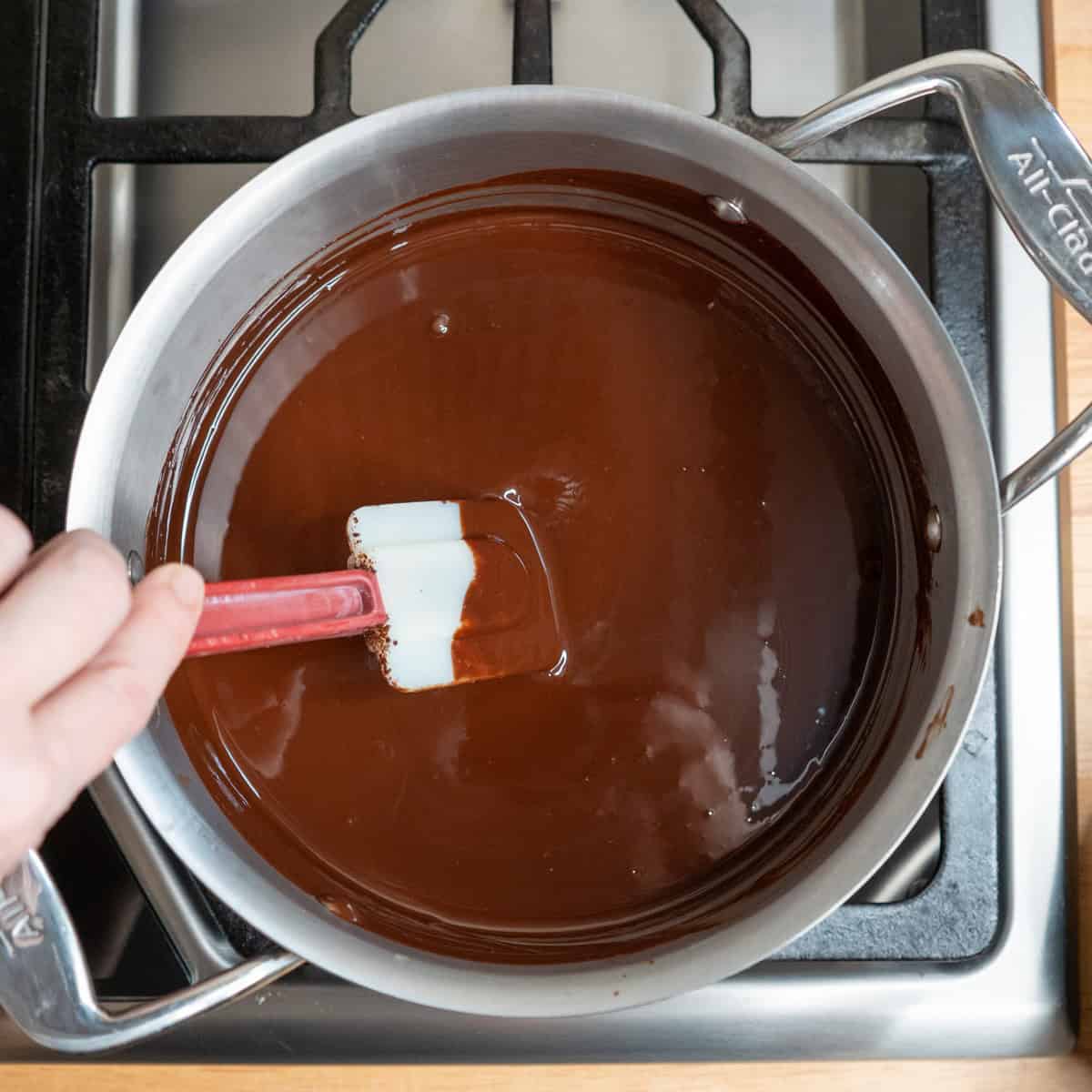 Chocolate and butter melted together in a saucepan.