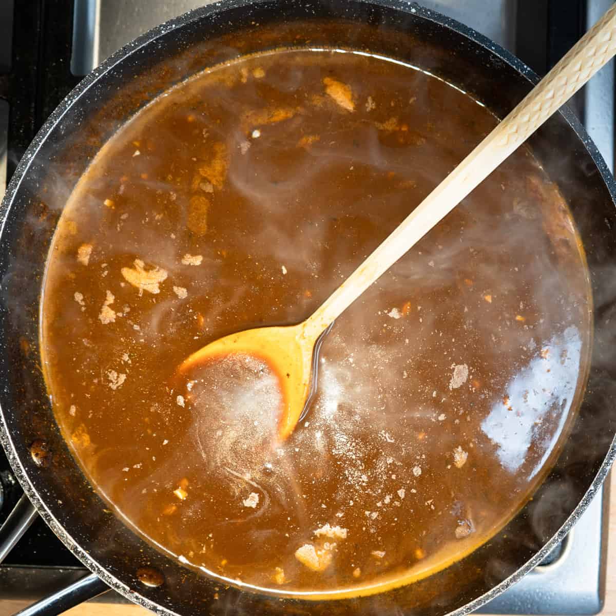 Gravy for the stew thickened in a skillet.