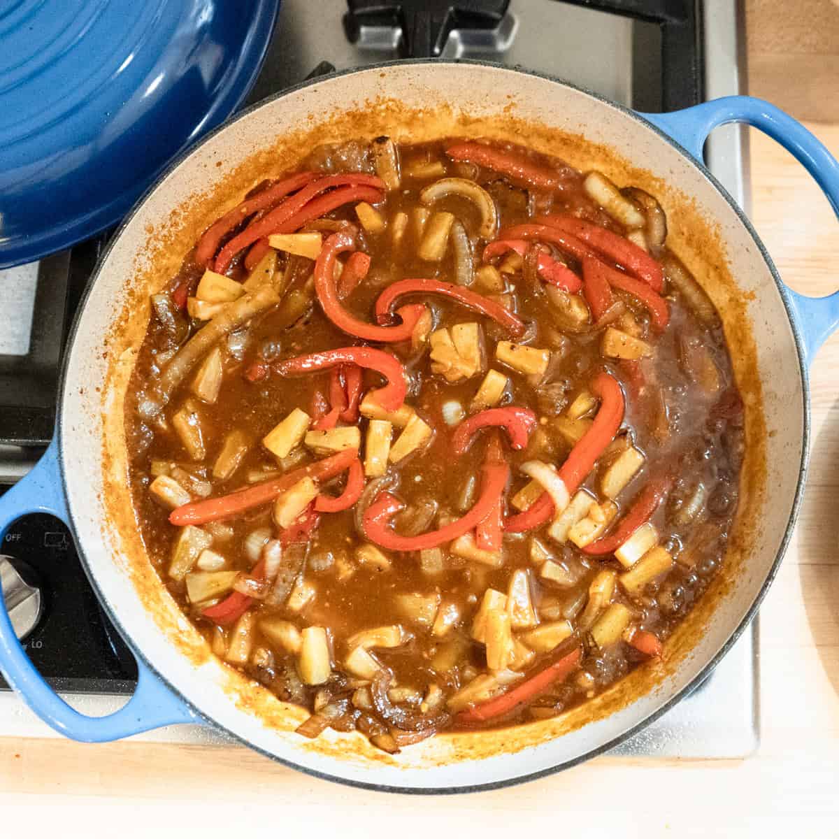 Sweet and sour pineapple sauce cooking in a pan.