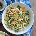 One serving of chickpea and tuna salad sitting on a blue towel.