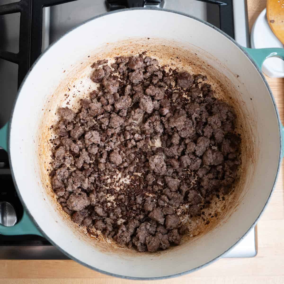 Ground beef browning in a large pot.