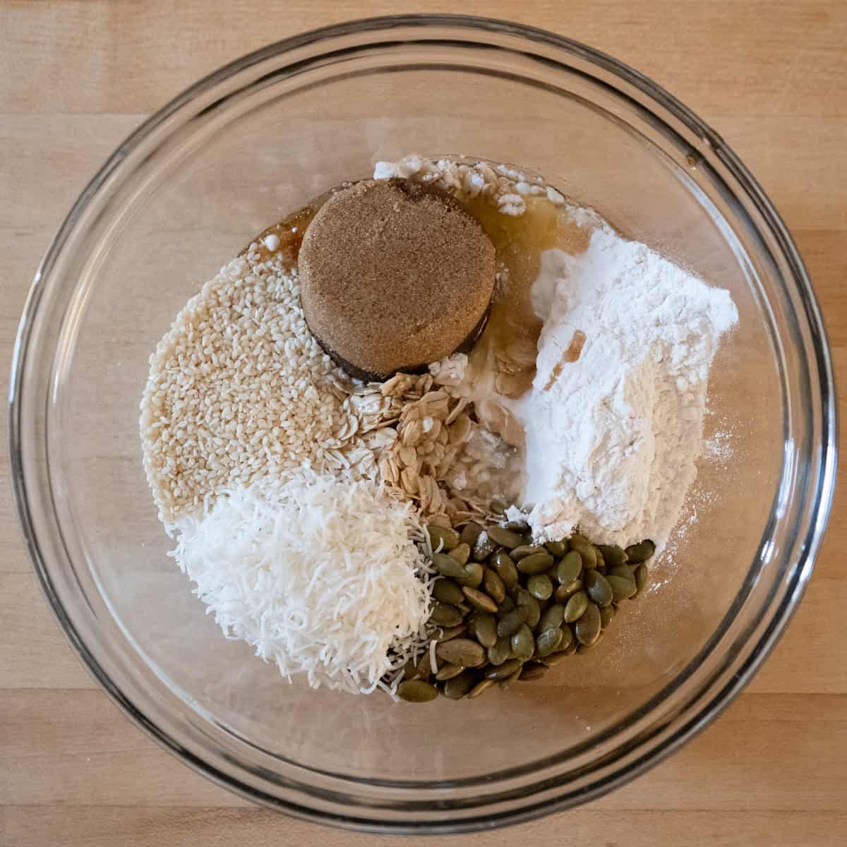 All of the crisp topping ingredients in a glass bowl waiting to be mixed together.